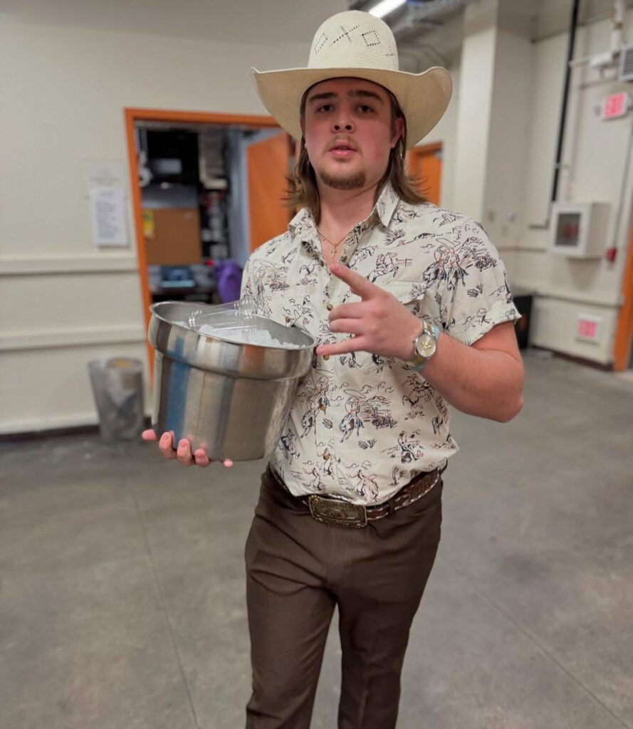 Colin Stough in his house holding a pot