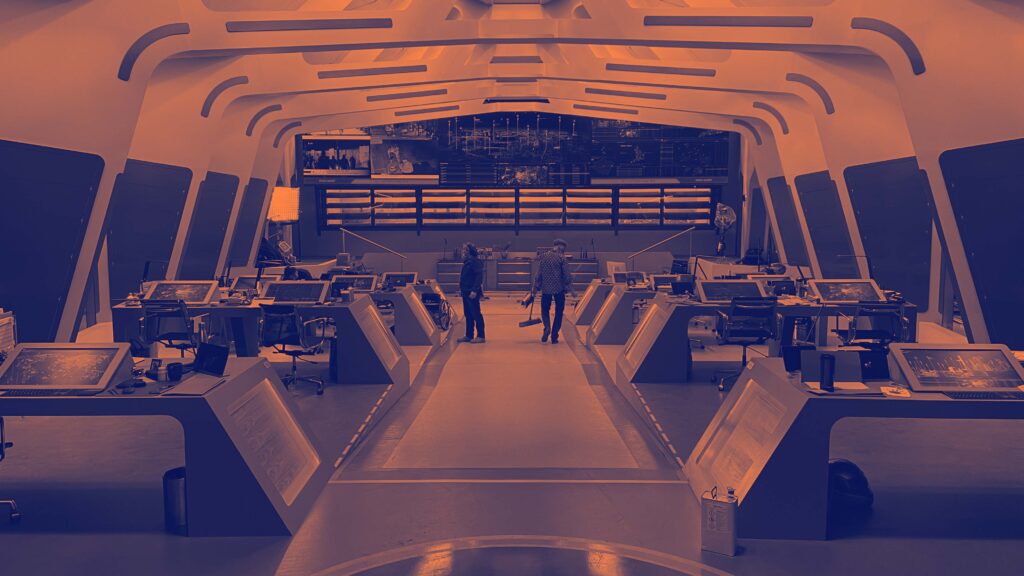 An expansive area featuring many computers and people, illustrating a dynamic workspace atmosphere.